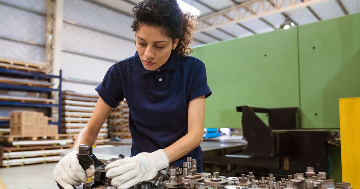 Woman using manufacturing machinery